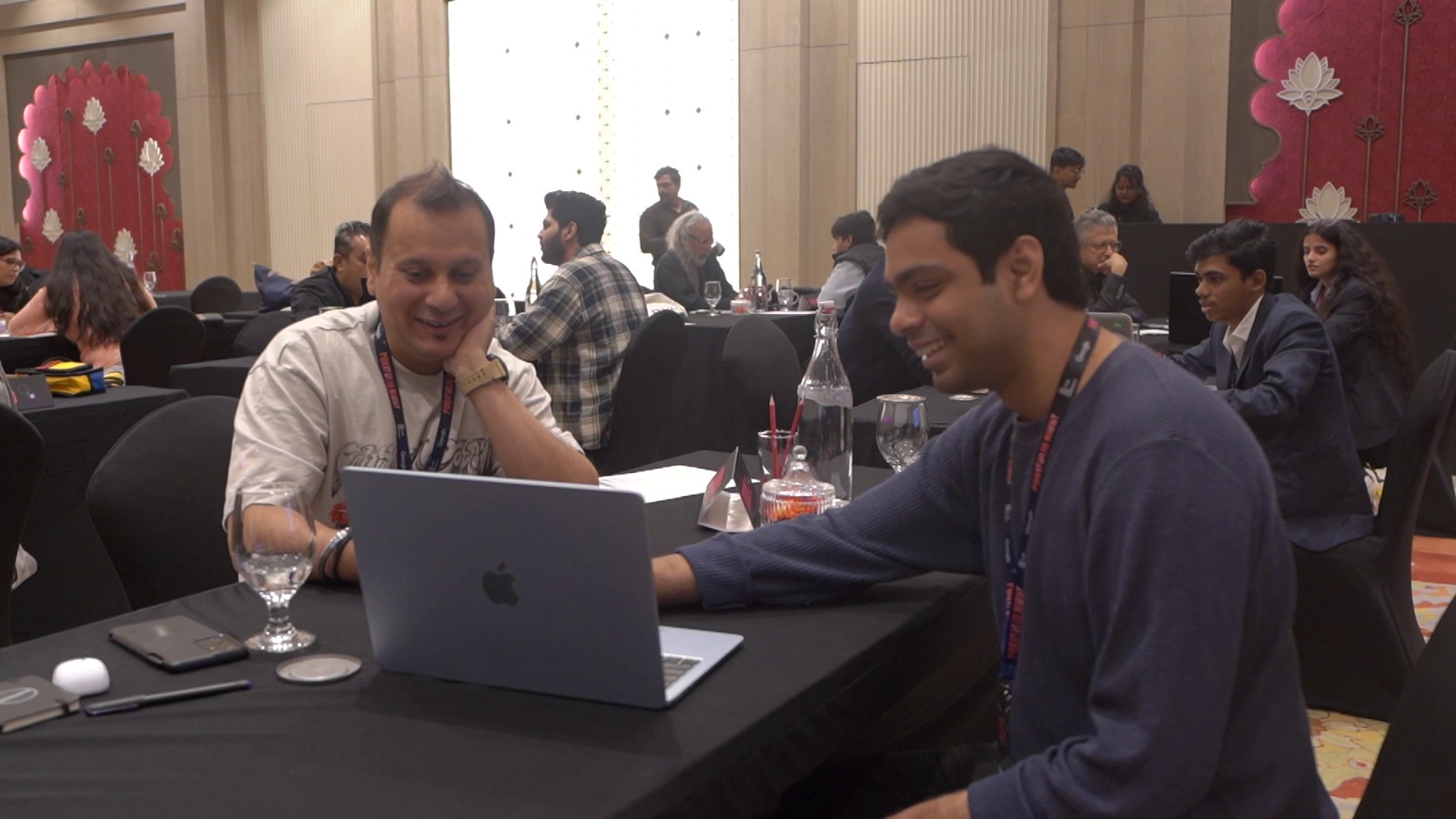 A reviewer and a creative going through work at Portfolio Night Delhi 2025